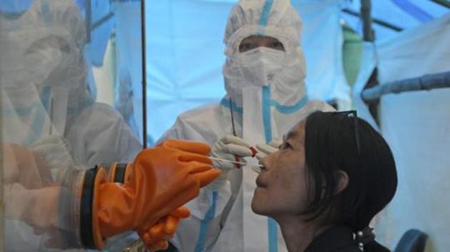A health worker takes a nasal swab sample to test for Covid-19 in Kohima. (AP File) A health worker takes a nasal swab sample to test for Covid-19 in Kohima. (AP File)