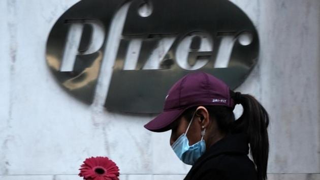 A woman walks by Pfizer's New York headquarters as New York City tries to contain a spike in Covid-19 cases on November 16, 2020 in New York City. (AFP) A woman walks by Pfizer's New York headquarters as New York City tries to contain a spike in Covid-19 cases on November 16, 2020 in New York City. (AFP)