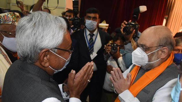 Chief minister Nitish Kumar with Union home minister Amit Shah during the oath taking ceremony at Raj Bhawan, in Patna, Bihar on November 16, 2020.(Santosh Kumar/HT Photo)