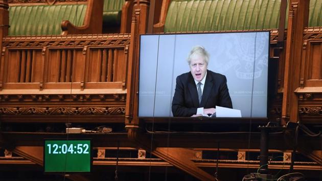 A handout photograph released by the UK Parliament shows a screen displaying an image of Britain's Prime Minister Boris Johnson as he takes part remotely via a Zoom video call in the weekly Prime Minister's Questions (PMQs) with Labour Leader Keir Starmer, in a hybrid, socially distanced session in the House of Commons in London on November 18.(AFP)