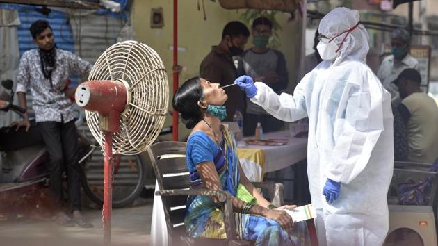 A woman sits to give a swab sample for Covid-19 screening at Malad (E) in Mumbai on November 17. The state of Maharashtra on the other hand, with a significantly larger population and area reported 5,123 cases during the same period. (Satyabrata Tripathy / HT Photo) A woman sits to give a swab sample for Covid-19 screening at Malad (E) in Mumbai on November 17. The state of Maharashtra on the other hand, with a significantly larger population and area reported 5,123 cases during the same period. (Satyabrata Tripathy / HT Photo)