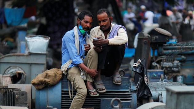 Men wearing protective face masks incorrectly bide time at a second-hand motor parts market in Delhi on November 16. Delhi government is now looking to re-enforce curbs on wedding attendees to 50 and has asked the Union government for powers to lock down markets if they turn into hot spots. Decisions are also being made on house-to-house surveillance of active cases and Delhi’s containment strategy. (Adnan Abidi / REUTERS) Men wearing protective face masks incorrectly bide time at a second-hand motor parts market in Delhi on November 16. Delhi government is now looking to re-enforce curbs on wedding attendees to 50 and has asked the Union government for powers to lock down markets if they turn into hot spots. Decisions are also being made on house-to-house surveillance of active cases and Delhi’s containment strategy. (Adnan Abidi / REUTERS)