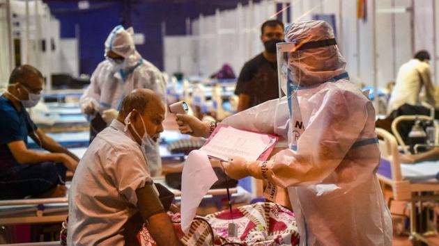 Doctors check patients at CWG village COVID-19 Care Centre, near Akshardham in New Delhi. (PTI) Doctors check patients at CWG village COVID-19 Care Centre, near Akshardham in New Delhi. (PTI)