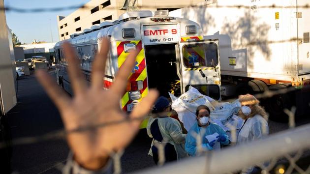 An El Paso County Sheriff’s Officer tries to block photographs from being taken as bodies are moved to refrigerated trailers outside the Medical Examiner’s Office in El Paso, Texas on November 16. The state of Texas’s death toll from coronavirus infection has crossed 20,000 – chalking up America’s second highest number of deaths and trailing only New York. (Ivan Pierre Aguirre / REUTERS) An El Paso County Sheriff’s Officer tries to block photographs from being taken as bodies are moved to refrigerated trailers outside the Medical Examiner’s Office in El Paso, Texas on November 16. The state of Texas’s death toll from coronavirus infection has crossed 20,000 – chalking up America’s second highest number of deaths and trailing only New York. (Ivan Pierre Aguirre / REUTERS)