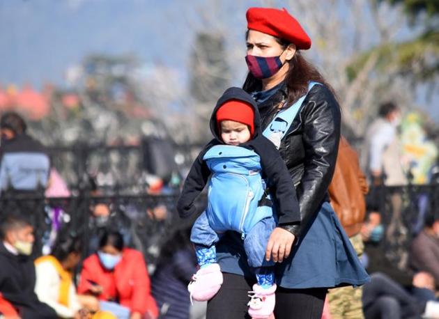 A woman carrying her child at the Ridge in Shimla on a sunny but chilly Friday afternoon. (Deepak Sansta/HT) A woman carrying her child at the Ridge in Shimla on a sunny but chilly Friday afternoon. (Deepak Sansta/HT)