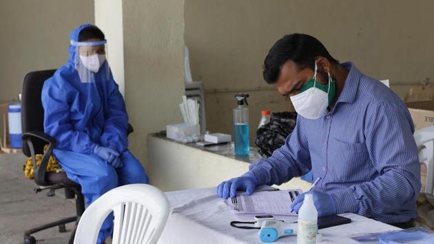 Health staff while taking swab samples at a Covid-19 testing centre in Pune, on Thursday.(Ravindra Joshi/HT PHOTO)