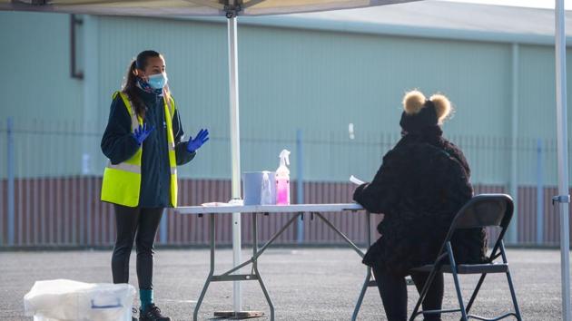 A woman is instructed how to perform a self Covid-19 test at a testing centre at Liverpool Tennis Centre in Liverpool, UK in this file photo.(Bloomberg Photo) A woman is instructed how to perform a self Covid-19 test at a testing centre at Liverpool Tennis Centre in Liverpool, UK in this file photo.(Bloomberg Photo)