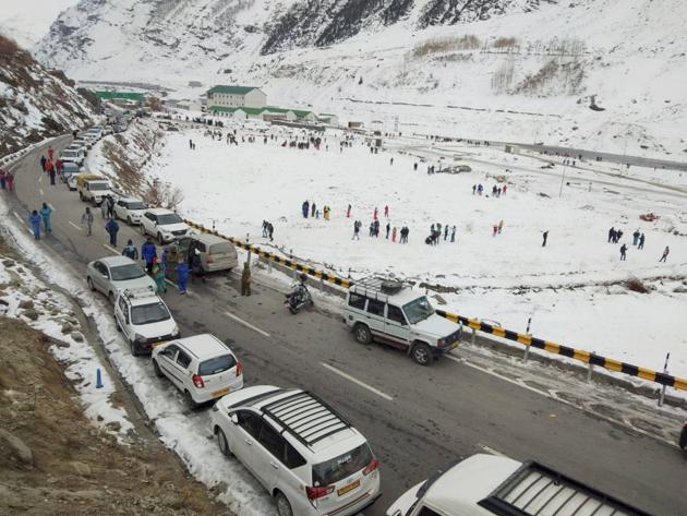 Tourists visit snow-covered fields after snowfall, near Atal Tunnel in Sissu, Lahaul-Spiti on Thursday, November 19.(PTI)