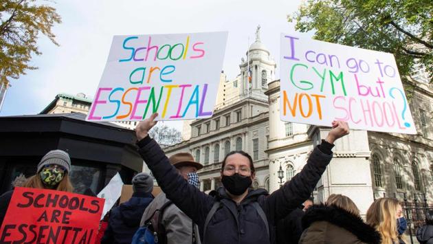 Parents protest demanding that public schools remain open, outside New York’s City Hall on November 19. President-elect Joe Biden has defied all possibilities of a nationwide lockdown in wake of the rising cases. However, New York City on November 19 closed its schools – affecting nearly 1.1 million students. (Kena Betancur / AFP) Parents protest demanding that public schools remain open, outside New York’s City Hall on November 19. President-elect Joe Biden has defied all possibilities of a nationwide lockdown in wake of the rising cases. However, New York City on November 19 closed its schools – affecting nearly 1.1 million students. (Kena Betancur / AFP)