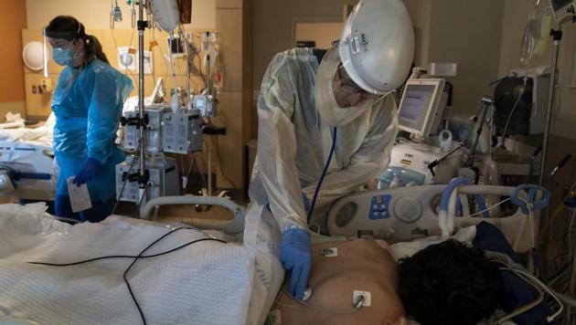 Dr. Rafik Abdou checks on a Covid-19 patient at Providence Holy Cross Medical Center in the Mission Hills section of Los Angeles, Thursday.(AP File Photo)