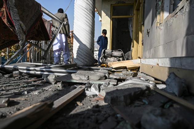 People inspect a damaged house after several rockets land at Khair Khana, north west of Kabul(AFP)