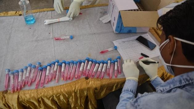 A health worker in PPE works with samples taken for coronavirus testing in New Delhi on November 18. Concurrent with the Covid-19 case surge, India’s total number of Covid-19 tests have now crossed the 130 million mark, the Ministry of Health announced on November 21. Of these, the last 10 million tests came in just 10 days, the ministry posted on Twitter. (Sanchit Khanna / HT Photo)
