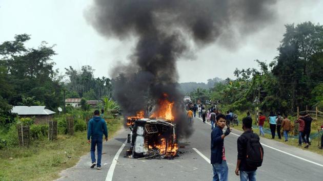 A vehicle in flames during a protest by the Joint Movement Committee (JMC) against the resettlement of displaced Bru migrants in Kanchanpur sub-division, at Panisagar in North Tripura district.(PTI) A vehicle in flames during a protest by the Joint Movement Committee (JMC) against the resettlement of displaced Bru migrants in Kanchanpur sub-division, at Panisagar in North Tripura district.(PTI)