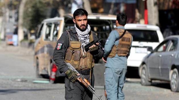 A police officer stands guard after rockets hit residential areas in Kabul, Afghanistan.(REUTERS) A police officer stands guard after rockets hit residential areas in Kabul, Afghanistan.(REUTERS)