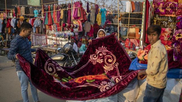 People shop for blankets at a market on the outskirts of New Delhi on November 20. “The drop in night temperature is mainly due to a combination of cold winds blowing from the snow-clad western Himalayan region and largely clear skies in Delhi. When there is no cloud cover, the ground cools faster and minimum temperatures stay low,” Kuldeep Srivastava, head of IMD’s regional weather forecasting centre, told HT. (Altaf Qadri / AP) People shop for blankets at a market on the outskirts of New Delhi on November 20. “The drop in night temperature is mainly due to a combination of cold winds blowing from the snow-clad western Himalayan region and largely clear skies in Delhi. When there is no cloud cover, the ground cools faster and minimum temperatures stay low,” Kuldeep Srivastava, head of IMD’s regional weather forecasting centre, told HT. (Altaf Qadri / AP)
