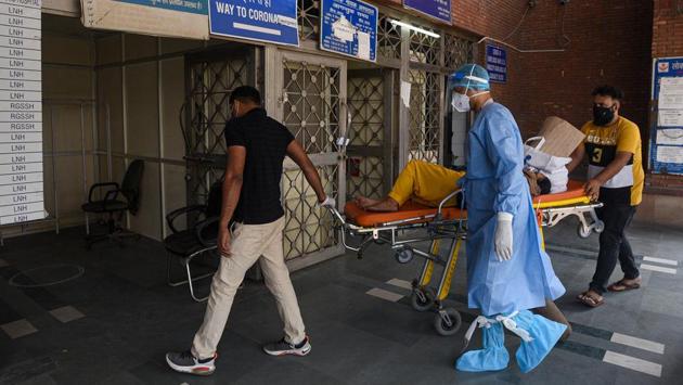 A patient suspected of coronavirus infection is taken from an ambulance into the Covid-19 ward at Lok Nayak Jai Prakash (LNJP) Hospital in New Delhi on November 18. In preparedness for a worse Covid-19 situation in Delhi, the state government has added 663 ICU beds in its hospitals. (Biplov Bhuyan / HT Photo) A patient suspected of coronavirus infection is taken from an ambulance into the Covid-19 ward at Lok Nayak Jai Prakash (LNJP) Hospital in New Delhi on November 18. In preparedness for a worse Covid-19 situation in Delhi, the state government has added 663 ICU beds in its hospitals. (Biplov Bhuyan / HT Photo)