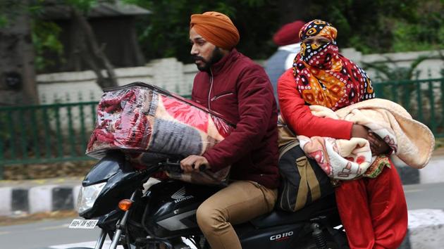 Commuters ride along Mall Road with winter warmers in Patiala on November 20. According to scientists, winter has arrived in many parts of northwest India, both in the hills and the northern plains, with the minimum temperature dipping 5 degrees Celsius below normal in several cities, HT reported. (Bharat Bhushan / HT Photo)
