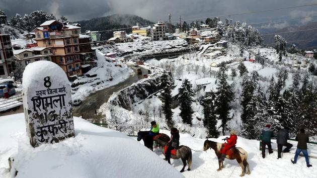Tourists seen at Kufri after a fresh spell of snowfall in Shimla on November 20. According to scientists, the onset of winter, which usually takes place around mid-December, seems to be happening earlier due to the influence of back-to-back western disturbances, HT reported. (Deepak Sansta / HT Photo)