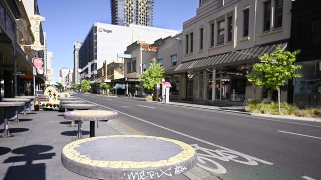 Tables stand vacant in a nearly empty pedestrian mall in Adelaide, Australia.(AP)