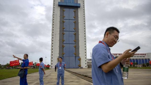 Workers gather near a building at the Wenchang Space Launch Site in Wenchang in southern China's Hainan province, Monday, Nov. 23, 2020. (AP photo) Workers gather near a building at the Wenchang Space Launch Site in Wenchang in southern China's Hainan province, Monday, Nov. 23, 2020. (AP photo)