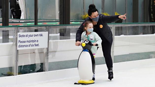 People ice skate as the Rink at Rockefeller Center opens for the season with limited capacity and additional safety precautions on November 21 in New York City. The pandemic has already caused long-term repercussions throughout the tourism and entertainment industries, including temporary and permanent closures of historic and iconic venues, costing businesses billions in revenue. (Cindy Ord / Getty Images / AFP) People ice skate as the Rink at Rockefeller Center opens for the season with limited capacity and additional safety precautions on November 21 in New York City. The pandemic has already caused long-term repercussions throughout the tourism and entertainment industries, including temporary and permanent closures of historic and iconic venues, costing businesses billions in revenue. (Cindy Ord / Getty Images / AFP)