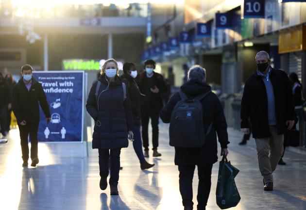People walk through Waterloo station, amid the coronavirus disease outbreak, in London on November 23.(REUTERS)