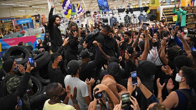 Demonstrators make a barrier out of car tyres during a protest inside the supermarket Carrefour in Rio de Janeiro on November 20. Mass protests in Brazil were triggered by a video taken on November 19 night in Porto Alegre that showed 40-year-old welder Joao Alberto Silveira Freitas repeatedly being punched in the face and head by a security guard while he was being restrained by another at a Carrefour market, AFP reported. (Carl De Souza / AFP) Demonstrators make a barrier out of car tyres during a protest inside the supermarket Carrefour in Rio de Janeiro on November 20. Mass protests in Brazil were triggered by a video taken on November 19 night in Porto Alegre that showed 40-year-old welder Joao Alberto Silveira Freitas repeatedly being punched in the face and head by a security guard while he was being restrained by another at a Carrefour market, AFP reported. (Carl De Souza / AFP)