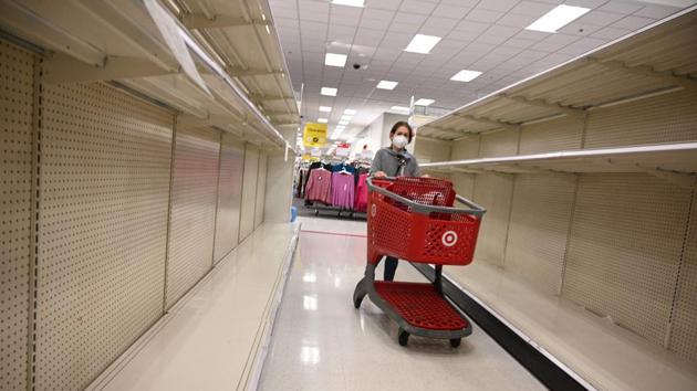 A shopper walks by empty shelves in the paper products aisle of a store in Burbank, California on November 19. Paper towels and other cleaning supplies are once again flying off retail shelves amid a new wave of panic buying as the US rides a new surge in coronavirus infections. (Robyn Beck / AFP) A shopper walks by empty shelves in the paper products aisle of a store in Burbank, California on November 19. Paper towels and other cleaning supplies are once again flying off retail shelves amid a new wave of panic buying as the US rides a new surge in coronavirus infections. (Robyn Beck / AFP)