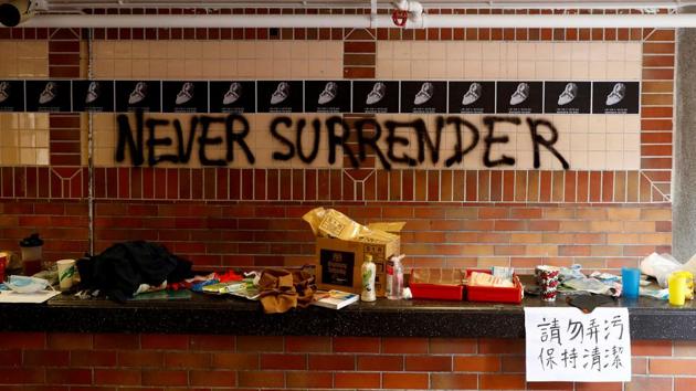 The slogan "Never Surrender" is spray painted on a wall in the besieged Hong Kong Polytechnic University (PolyU) in Hong Kong, China.(Reuters)