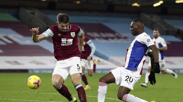 Burnley's James Tarkowski, left, duels for the ball with Crystal Palace's Christian Benteke during the English Premier League soccer match between Burnley and Crystal Palace at the Turf Moor stadium in Burnley, England, Monday, Nov. 23, 2020. (Jan Kruger/Pool via AP)(AP)