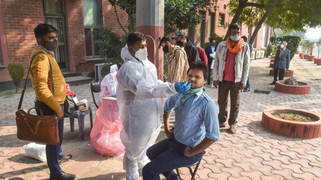 A health worker conducts Covid-19 testing near Delhi–Noida Direct flyover in Noida, on November 23.(PTI) A health worker conducts Covid-19 testing near Delhi–Noida Direct flyover in Noida, on November 23.(PTI)