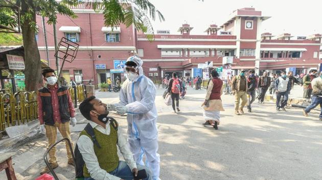 A health workers takes samples from a passenger for Covid-19 test, at Charbagh railway station in Lucknow.(PTI) A health workers takes samples from a passenger for Covid-19 test, at Charbagh railway station in Lucknow.(PTI)