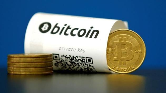 FILE PHOTO: A Bitcoin (virtual currency) paper wallet with QR codes and a coin are seen in an illustration picture taken at La Maison du Bitcoin in Paris, France, May 27, 2015. REUTERS/Benoit Tessier/File Photo