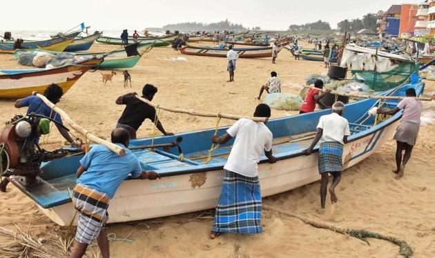 Fishermen shift their boats to safety following cyclone Nivar alert, in Mamallapuram on November 23.(PTI)