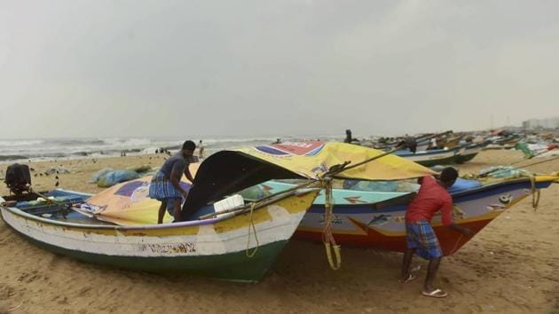 Fishermen cover their boats at Marina Beach during heavy rain, triggered by Cyclone Nivar,in Chennai.(PTI) Fishermen cover their boats at Marina Beach during heavy rain, triggered by Cyclone Nivar,in Chennai.(PTI)