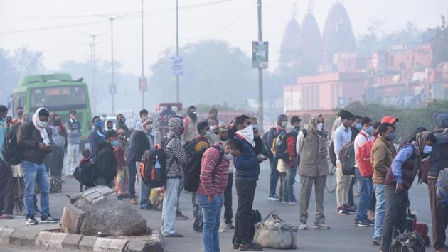 Commuters wait for DTC buses outside Red Fort in New Delhi on November 24. According to Srivastava, air quality in Delhi may improve slightly only around November 27-28 when wind speed is likely to pick up again after the passing of the western disturbance. (Arvind Yadav / HT Photo) 