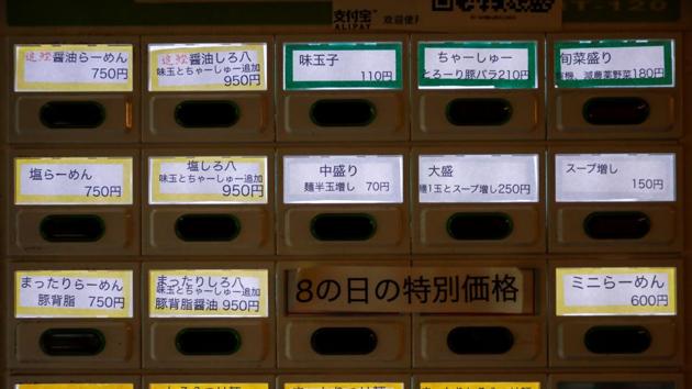 A vending machine for meal tickets is seen inside Shirohachi in Tokyo on November 20.Yashiro Haga tried offering his noodles through takeout but was unable to make up for the income he lost after office workers’ visits fell due to work-from-home restrictions. “Even among the most popular places, sales from takeout aren’t exceeding,” he told Reuters. (Issei Kato / Reuters)