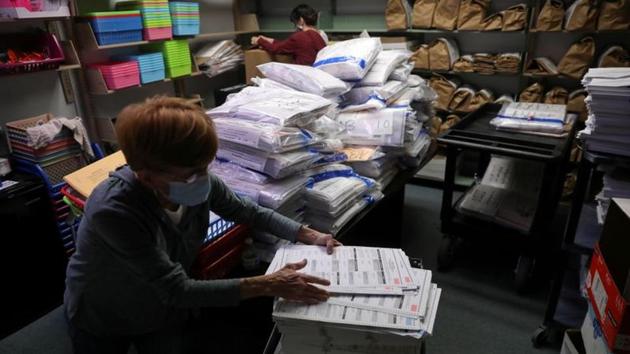 An election official works in the ballot room organizing unused ballots returned from voting precincts after election day at the Kenosha municipal building in Kenosha, Wisconsin, US.(Reuters) An election official works in the ballot room organizing unused ballots returned from voting precincts after election day at the Kenosha municipal building in Kenosha, Wisconsin, US.(Reuters)