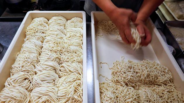 An employee of Shirohachi prepares noodles inside the shop in Tokyo on November 20. Japan’s small and mid-sized businesses like Haga’s noodle bar employ about 70% of the country’s workers and account for 99.7% of the total number of enterprises, Reuters reported from government’s data. (Issei Kato / Reuters)
