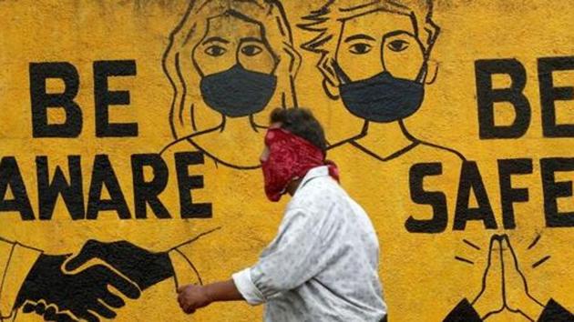 A man walks past a graffiti amid the spread of the coronavirus disease (Covid-19) in Mumbai.(Reuters)