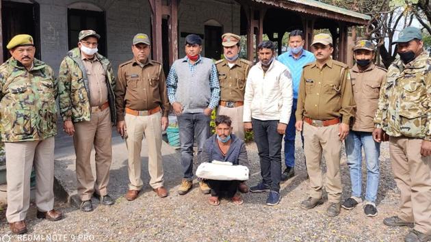 The Forest department team with the accused Nepali citizen in Champawat.(HT PHOTO.)