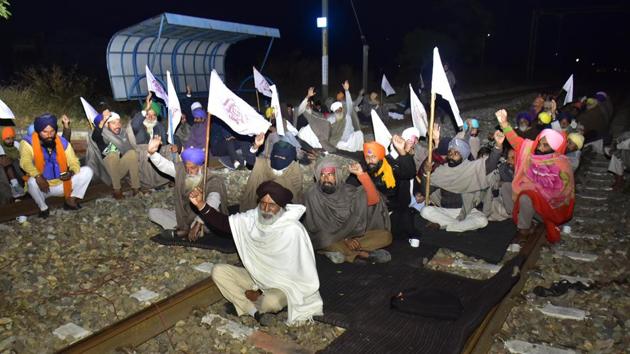 Farmers raise slogans while blocking a rail track at Jandiala Guru railway station to protest against Centre's new farm laws, in Amritsar, Punjab, on Tuesday.(HT Photo) Farmers raise slogans while blocking a rail track at Jandiala Guru railway station to protest against Centre's new farm laws, in Amritsar, Punjab, on Tuesday.(HT Photo)