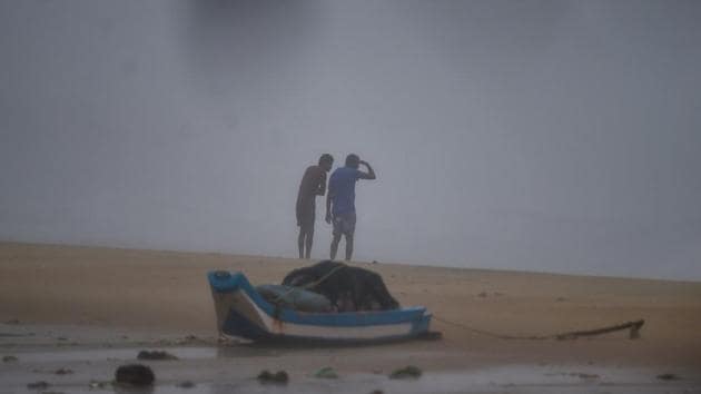 People stand near a shore during strong winds ahead of the landfall of Cyclone Nivar, in Kovalam, Wednesday, Nov. 25, 2020.(PTI photo) People stand near a shore during strong winds ahead of the landfall of Cyclone Nivar, in Kovalam, Wednesday, Nov. 25, 2020.(PTI photo)