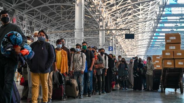 Passengers queue at a platform for Covid-19 screening after arriving from New Delhi at the railway station in Mumbai on November 25. As part of renewed stringency, some states have enforced mandatory tests on inter-state commuters from Delhi which is currently in going through its third wave of infections. Uttarakhand joined states like Maharashtra and Uttar Pradesh in mandating this measure on November 25. (Punit Paranjpe / AFP) Passengers queue at a platform for Covid-19 screening after arriving from New Delhi at the railway station in Mumbai on November 25. As part of renewed stringency, some states have enforced mandatory tests on inter-state commuters from Delhi which is currently in going through its third wave of infections. Uttarakhand joined states like Maharashtra and Uttar Pradesh in mandating this measure on November 25. (Punit Paranjpe / AFP)