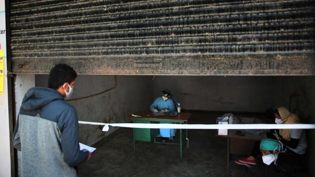 A person inquires at an OPD running in a garage at a hospital in Jaipur on November 23. The night curfew has also made a comeback amid apprehensions of a second wave. Punjab on November 25 became the latest state to announce a night curfew and doubled fines for not wearing masks or following social distancing norms. Punjab joins Rajasthan, Madhya Pradesh and Gujarat where night curfews have been selectively placed. (Himanshu Vyas / HT Photo) A person inquires at an OPD running in a garage at a hospital in Jaipur on November 23. The night curfew has also made a comeback amid apprehensions of a second wave. Punjab on November 25 became the latest state to announce a night curfew and doubled fines for not wearing masks or following social distancing norms. Punjab joins Rajasthan, Madhya Pradesh and Gujarat where night curfews have been selectively placed. (Himanshu Vyas / HT Photo)