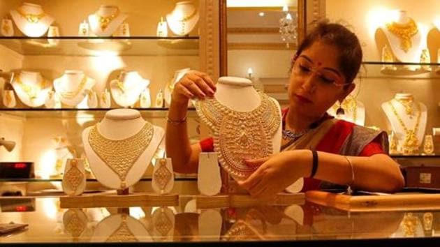 A saleswoman displays a gold necklace inside a jewellery showroom in Kolkata.(Reuters File Photo) A saleswoman displays a gold necklace inside a jewellery showroom in Kolkata.(Reuters File Photo)