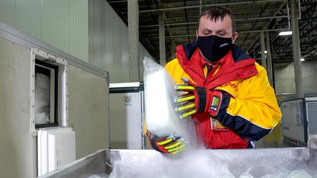 A DHL worker loads dry ice into "Envirotainers" inside an ultra-cold facility that is used for the shipment of vaccines, medical supplies and pharmaceuticals in Chicago, Illinois.(VIA REUTERS) A DHL worker loads dry ice into "Envirotainers" inside an ultra-cold facility that is used for the shipment of vaccines, medical supplies and pharmaceuticals in Chicago, Illinois.(VIA REUTERS)