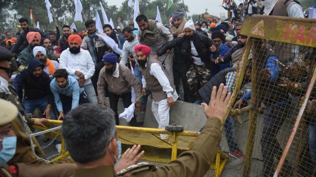 Farmers break past police barricades while marching towards Delhi, at Ambala on November 25. The march picked up steam on November 25, when multi-layer barricades on Punjab’s borders with Haryana were demolished by farmers using tractors as they continued their march towards the capital. (HT Photo) Farmers break past police barricades while marching towards Delhi, at Ambala on November 25. The march picked up steam on November 25, when multi-layer barricades on Punjab’s borders with Haryana were demolished by farmers using tractors as they continued their march towards the capital. (HT Photo)