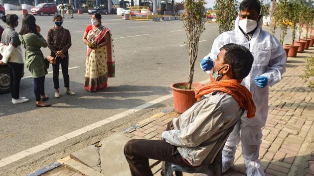 A health worker conducts Covid-19 testing near Delhi–Noida Direct (DND) flyover in Noida on Monday.(PTI Photo)