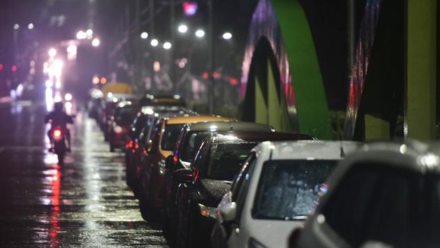 Residents park their vehicles on a flyover to prevent damage from Cyclone Nivar in Chennai on November 25. To further prevent any casualty from the cyclone,  all major arterial roads have been closed in Chennai in addition to the suspension of domestic and international flights. (R. Senthil Kumar / PTI) 